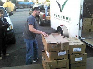 A man stacking boxes of donated food. 
